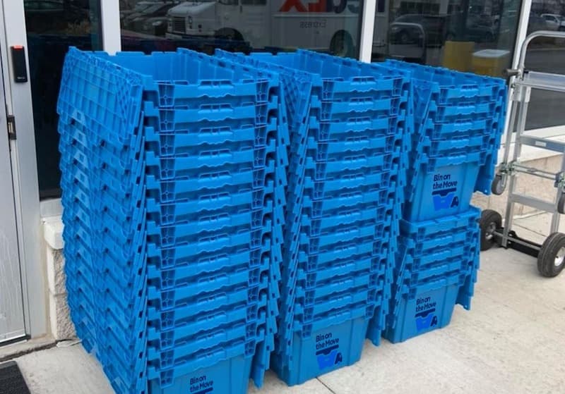 Empty reusable moving bins ready for pickup after a completed move